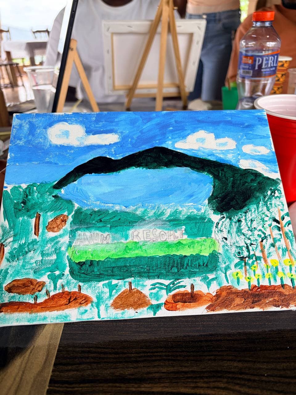 A finished landscape painting on an easel