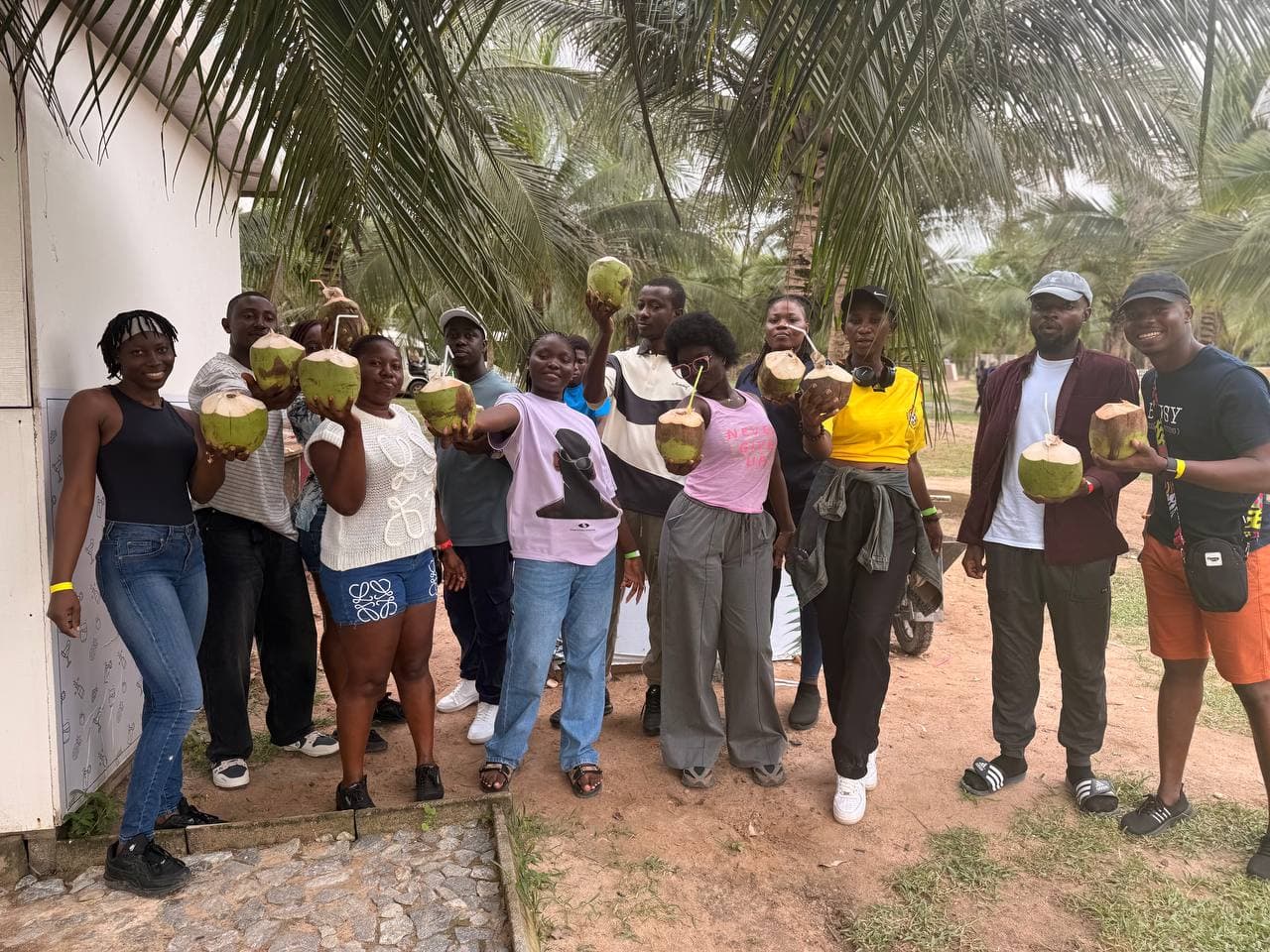 Guests sharing fresh coconuts on the lawn